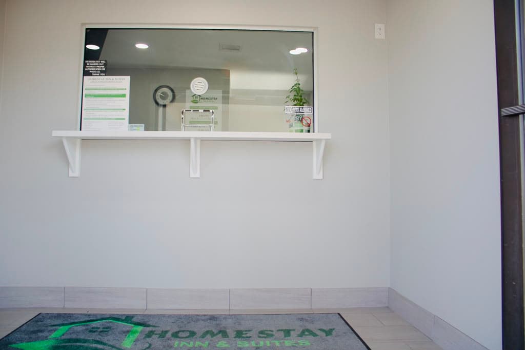 Lobby entrance with Homestay Inn & Suites welcome mat