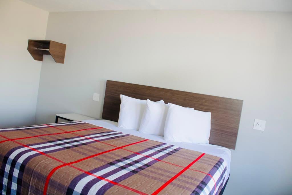 Suite with crisp white pillows and a warm plaid bedspread