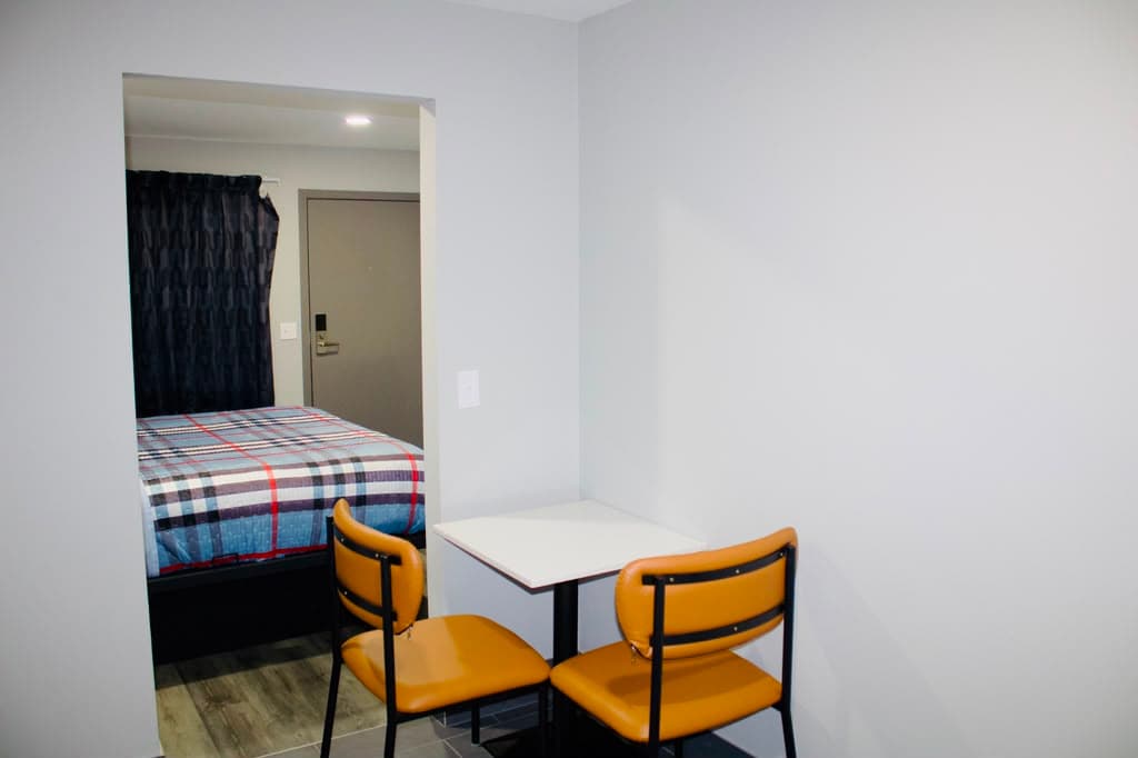 Dining nook with table and two chairs beside the bedroom