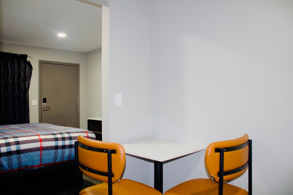 In-suite dining table with the entry door beyond