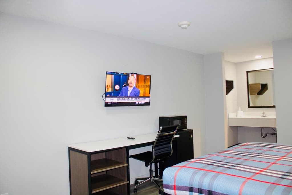 Desk and TV area with the vanity visible at the back of the suite