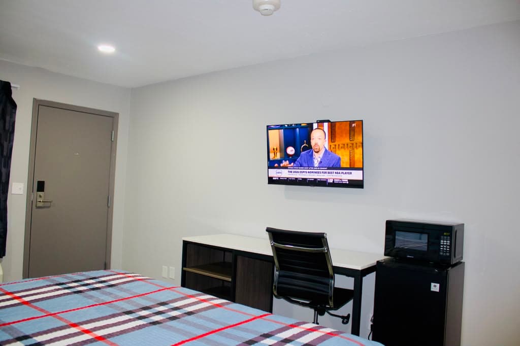 Entry area with desk, TV, microwave, and mini-fridge